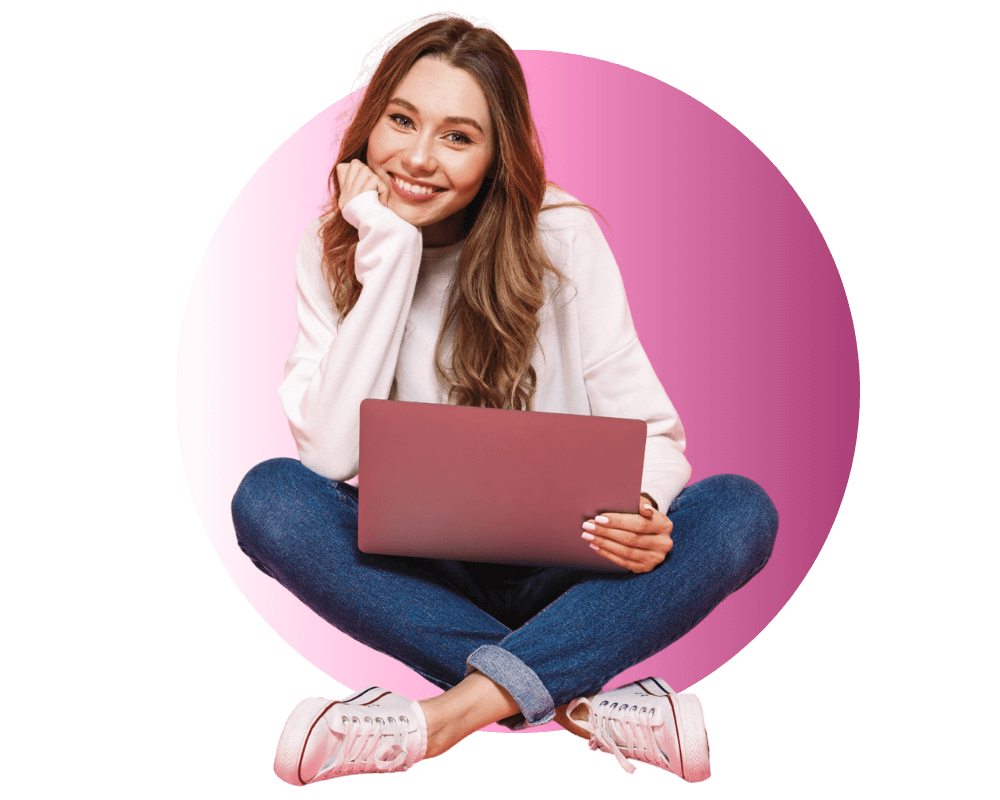 young female student sitting with a laptop on her lap smiling